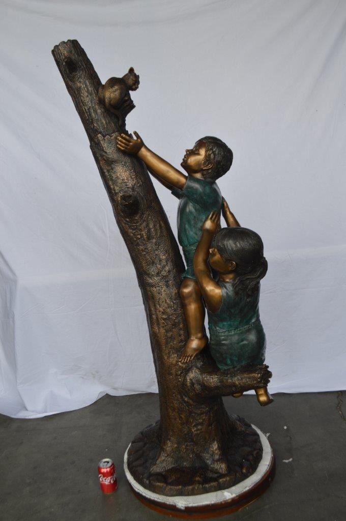 Children reaching up tree for a cat bronze statue - Size: 24"L x 21"W x 64"H.