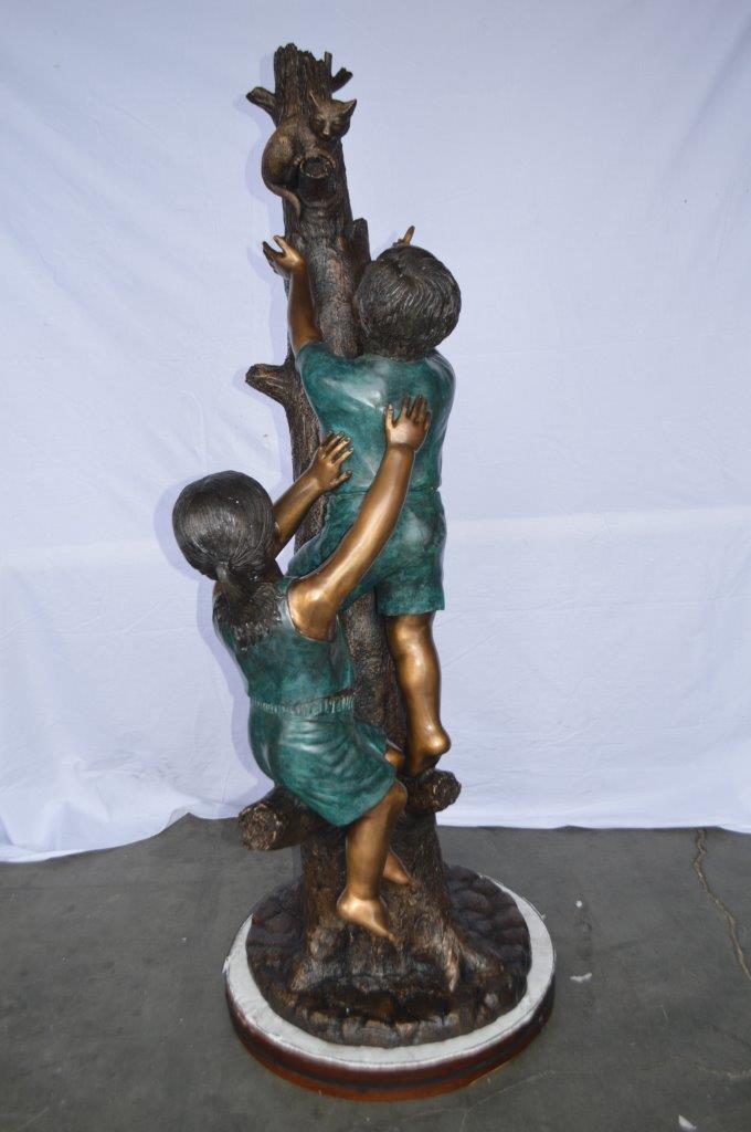 Children reaching up tree for a cat bronze statue - Size: 24"L x 21"W x 64"H.