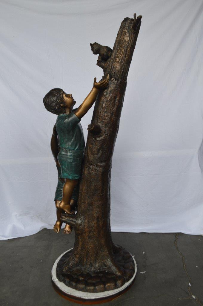 Children reaching up tree for a cat bronze statue - Size: 24"L x 21"W x 64"H.