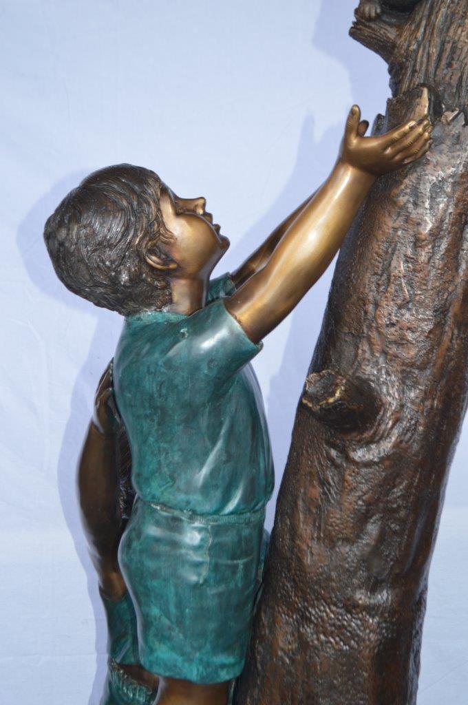 Children reaching up tree for a cat bronze statue -  Size: 24"L x 21"W x 64"H.