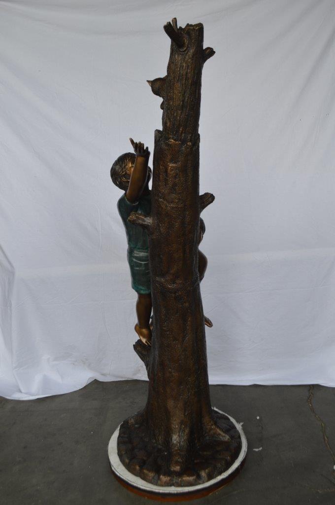 Children reaching up tree for a cat bronze statue -  Size: 24"L x 21"W x 64"H.