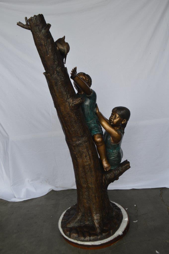 Children reaching up tree for a cat bronze statue - Size: 24"L x 21"W x 64"H.