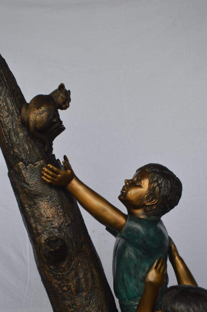 Children reaching up tree for a cat bronze statue - Size: 24"L x 21"W x 64"H.