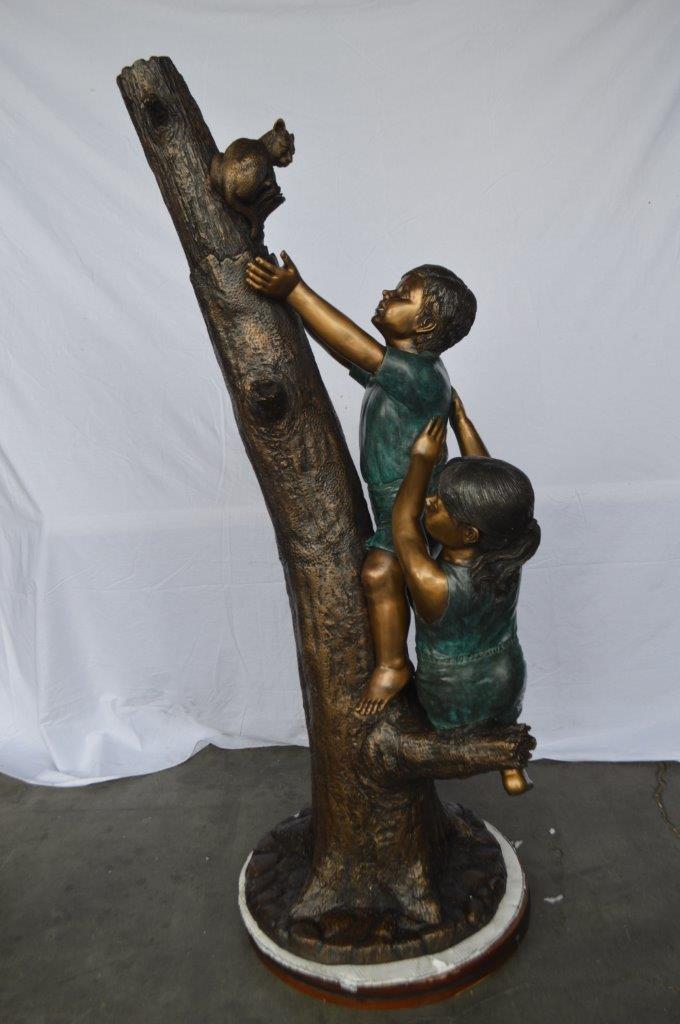 Children reaching up tree for a cat bronze statue - Size: 24"L x 21"W x 64"H.