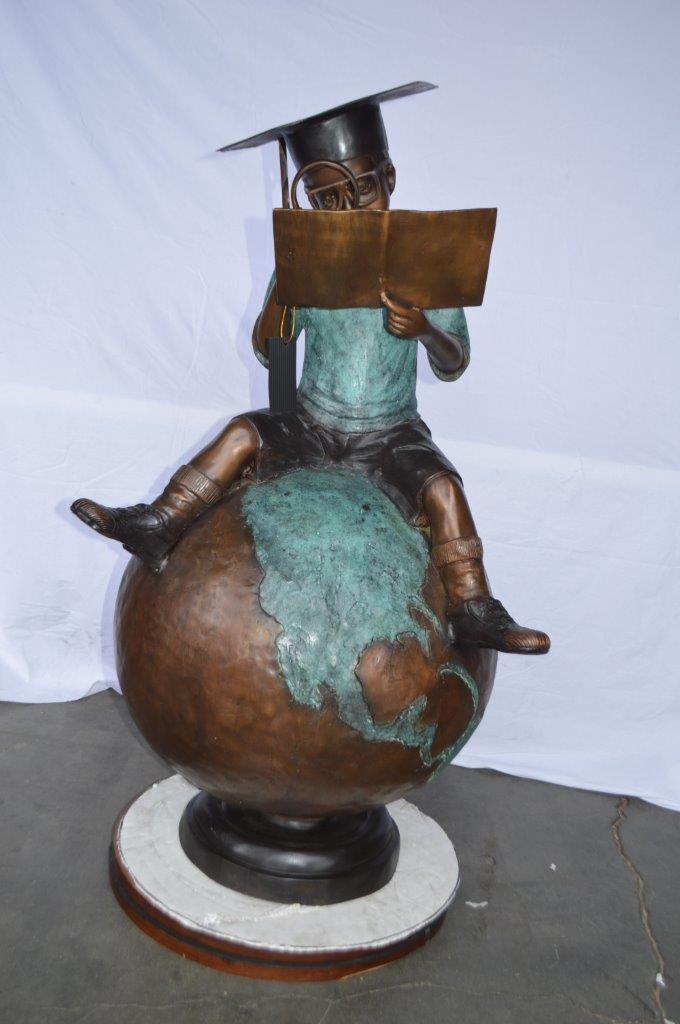 Student learning on top of world bronze statue - Size: 28"L x 24"W x 52"H.