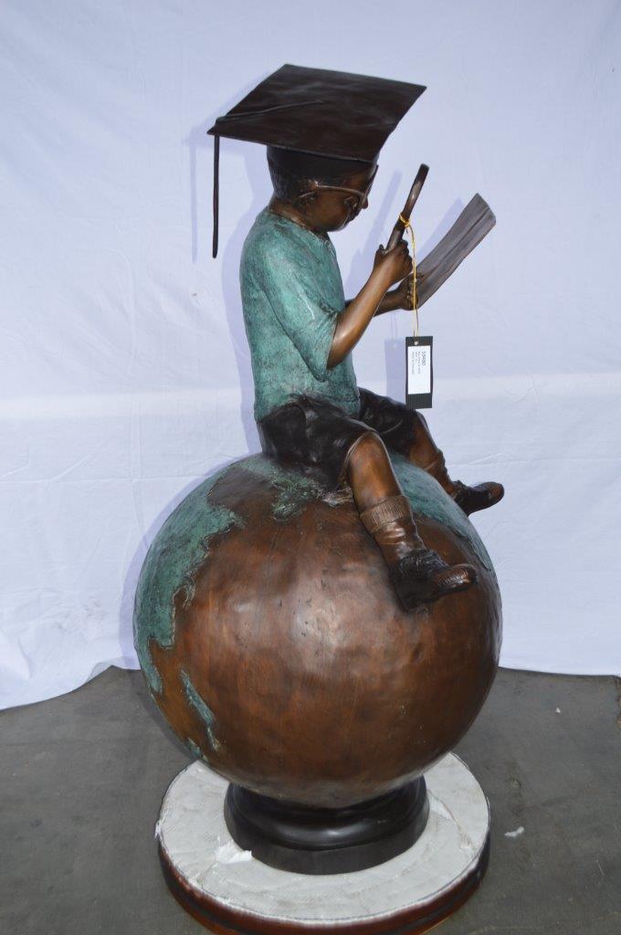 Student learning on top of world bronze statue - Size: 28"L x 24"W x 52"H.