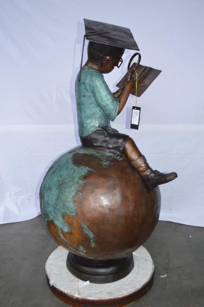 Student learning on top of world bronze statue - Size: 28"L x 24"W x 52"H.
