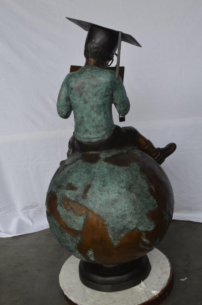 Student learning on top of world bronze statue - Size: 28"L x 24"W x 52"H.