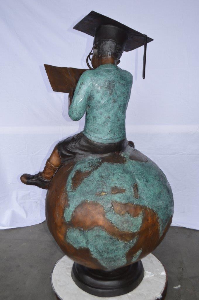 Student learning on top of world bronze statue - Size: 28"L x 24"W x 52"H.