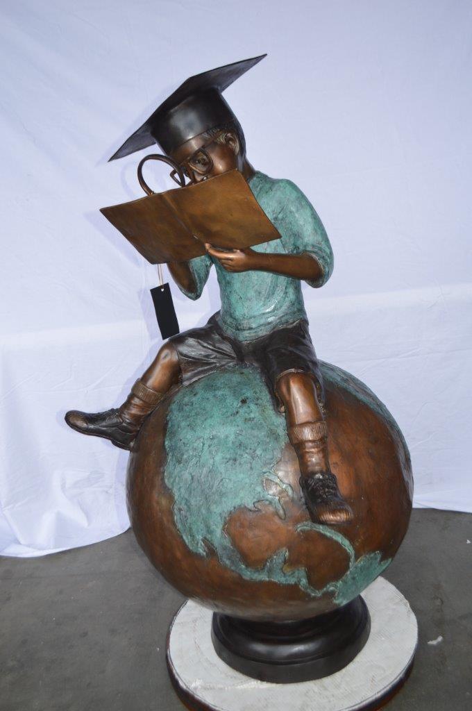 Student learning on top of world bronze statue - Size: 28"L x 24"W x 52"H.