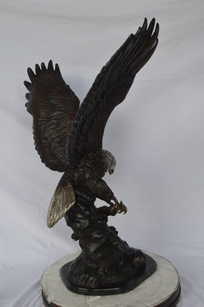 Eagle perched bronze statue - Size: 28"L x 18"W x 41"H.
