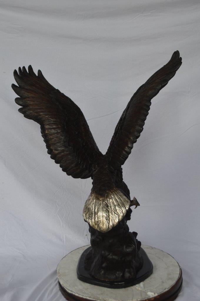 Eagle perched bronze statue - Size: 28"L x 18"W x 41"H.
