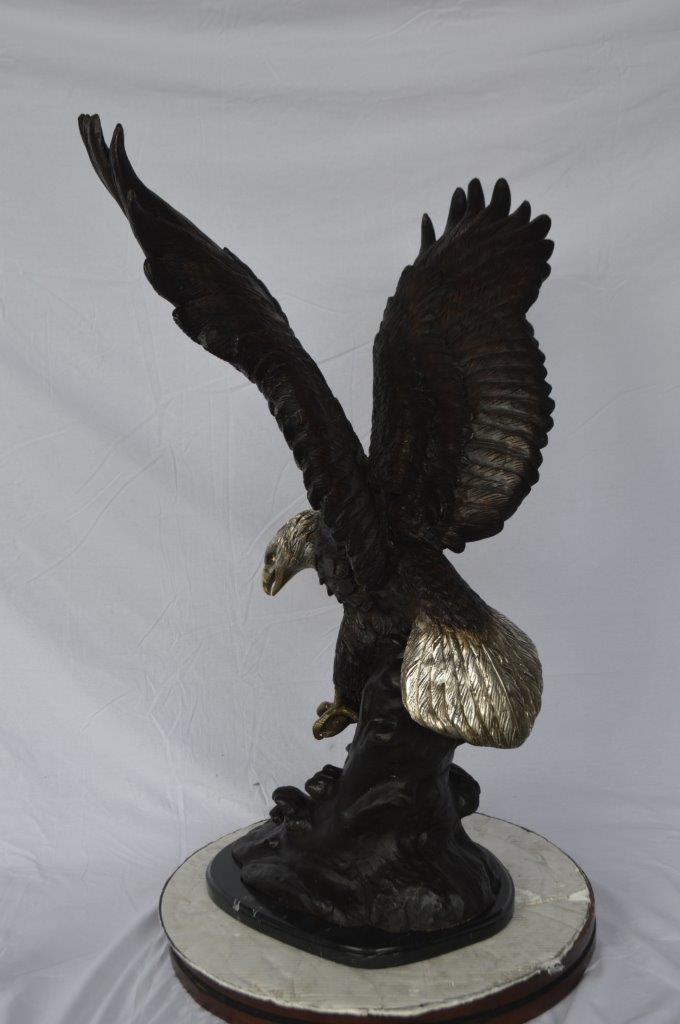 Eagle perched bronze statue - Size: 28"L x 18"W x 41"H.