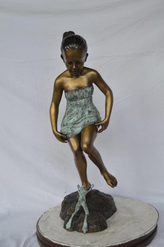 Girl looking at a frog bronze statue - Size: 16"L x 13"W x 36"H.