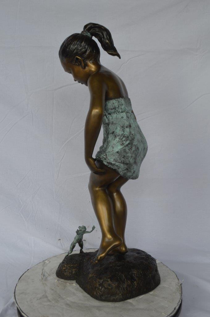 Girl looking at a frog bronze statue - Size: 16"L x 13"W x 36"H.