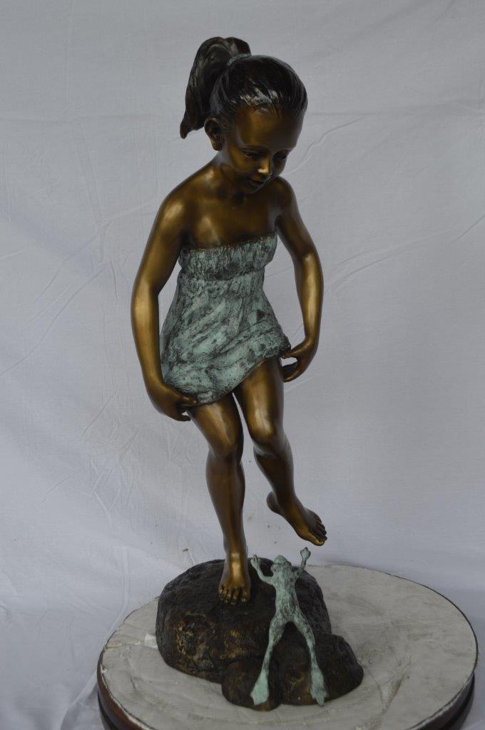 Girl looking at a frog bronze statue - Size: 16"L x 13"W x 36"H.