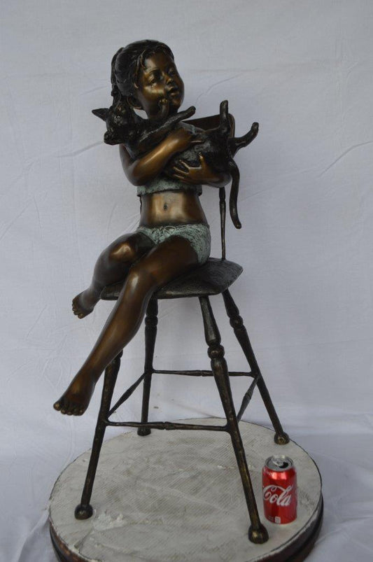 Girl with a cat on a high chair bronze statue - Size: 16"L x 16"W x 38"H.