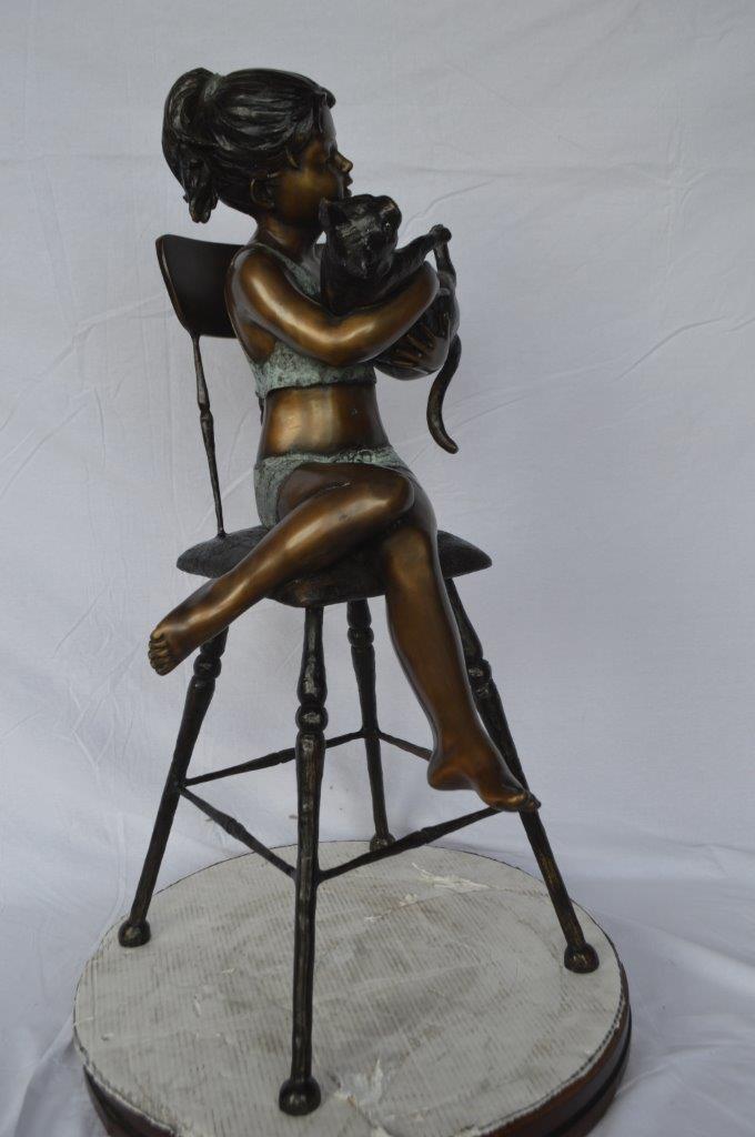 Girl with a cat on a high chair bronze statue - Size: 16"L x 16"W x 38"H.