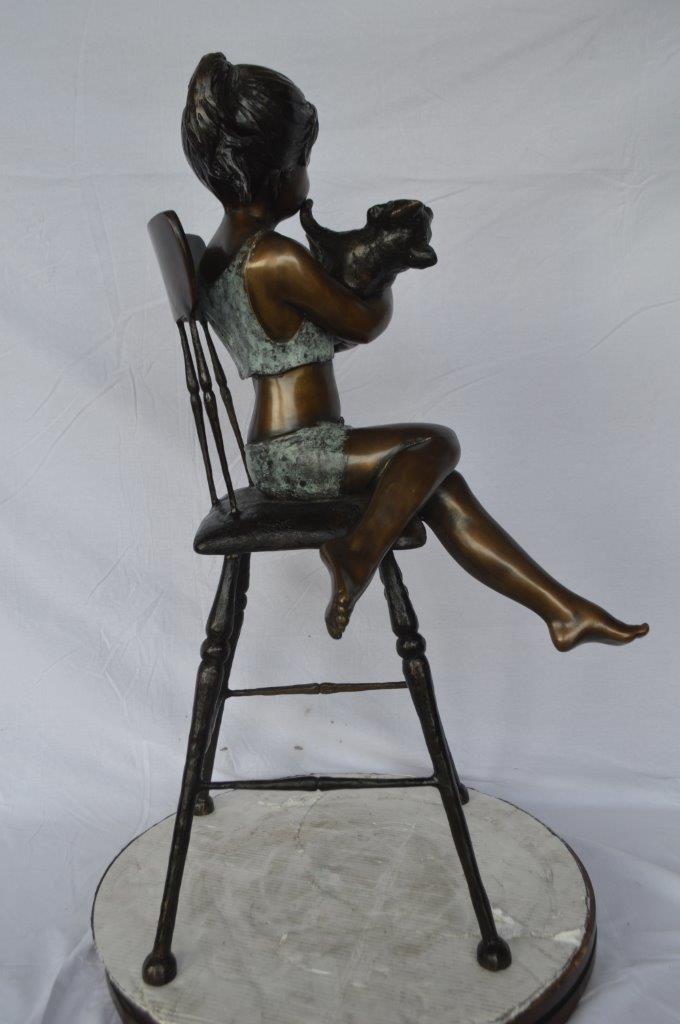 Girl with a cat on a high chair bronze statue - Size: 16"L x 16"W x 38"H.