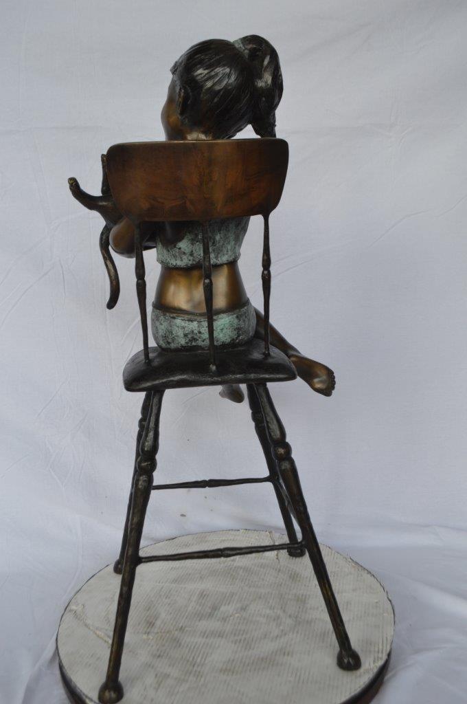 Girl with a cat on a high chair bronze statue - Size: 16"L x 16"W x 38"H.