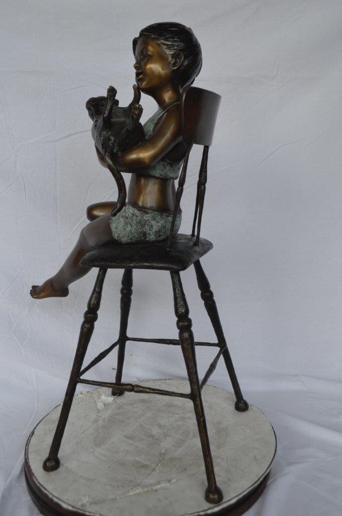 Girl with a cat on a high chair bronze statue -  Size: 16"L x 16"W x 38"H.