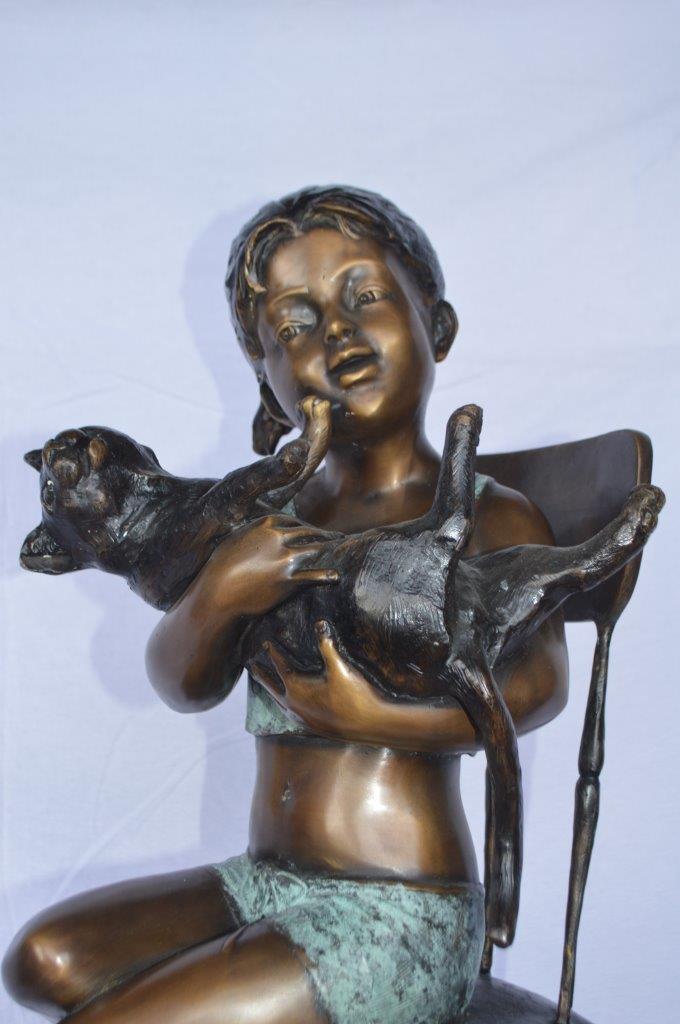 Girl with a cat on a high chair bronze statue - Size: 16"L x 16"W x 38"H.