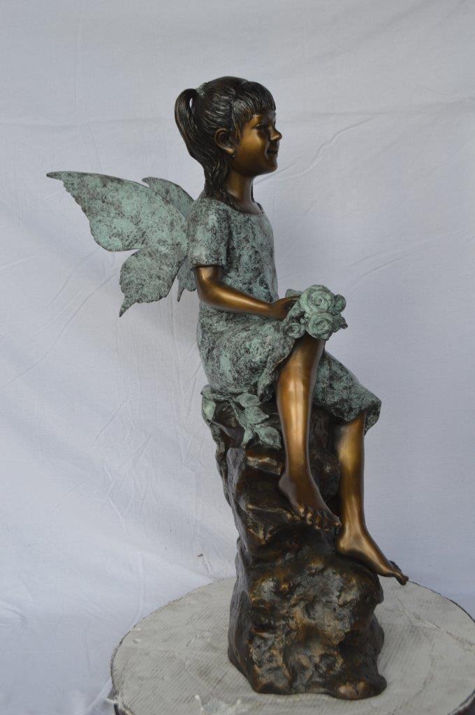 Angel girl sitting with a rose bronze statue -  Size: 22"L x 27"W x 37"H.