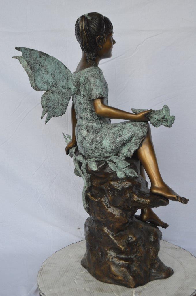 Angel girl sitting with a rose bronze statue -  Size: 22"L x 27"W x 37"H.