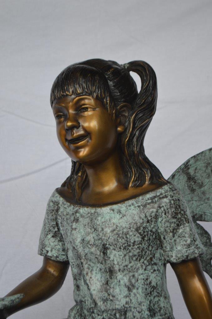 Angel girl sitting with a rose bronze statue -  Size: 22"L x 27"W x 37"H.