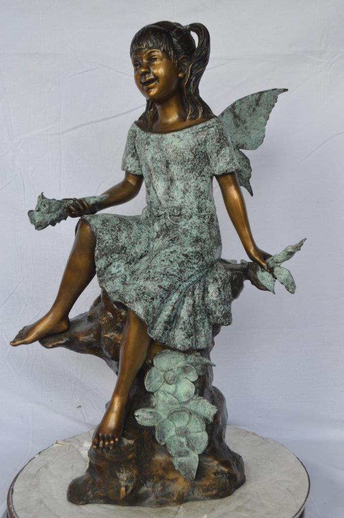 Angel girl sitting with a rose bronze statue -  Size: 22"L x 27"W x 37"H.