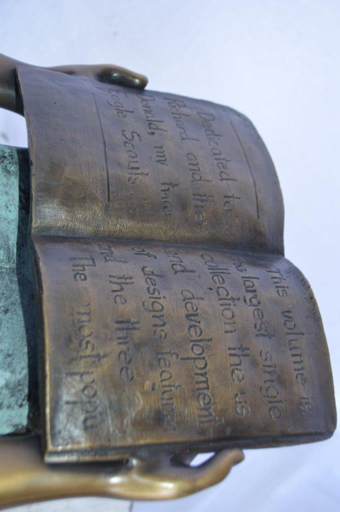 Young girl sitting and reading book bronze statue -  Size: 16"L x 12"W x 27"H.