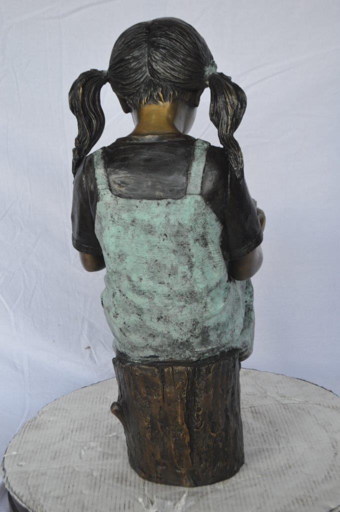 Young girl sitting and reading book bronze statue - Size: 16"L x 12"W x 27"H.
