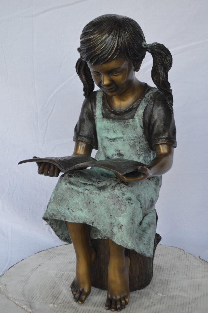 Young girl sitting and reading book bronze statue - Size: 16"L x 12"W x 27"H.