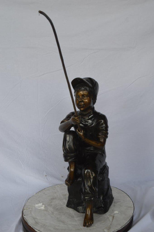 Young Boy sitting on a rock fishing bronze statue -  Size: 31"L x 9"W x 33"H.