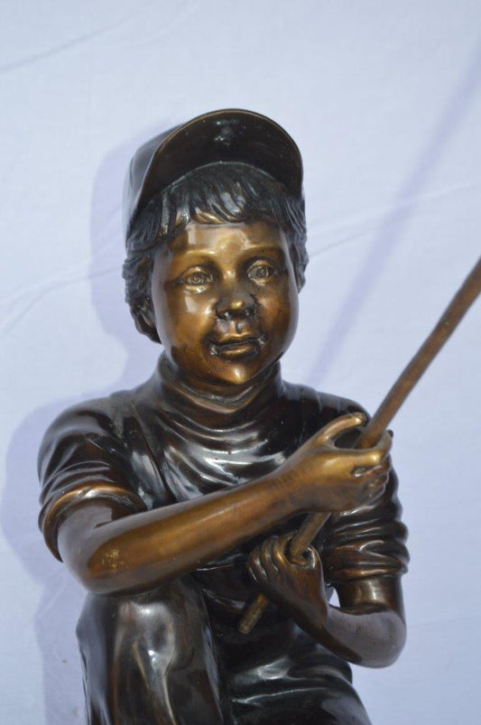 Young Boy sitting on a rock fishing bronze statue - Size: 31"L x 9"W x 33"H.