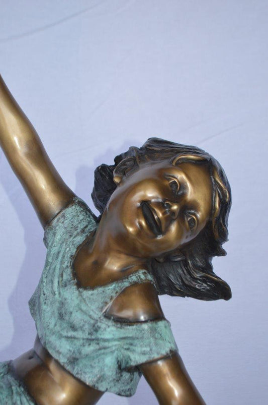 Girl having fun on apple bronze statue - Size: 22"L x 9"W x 31"H.