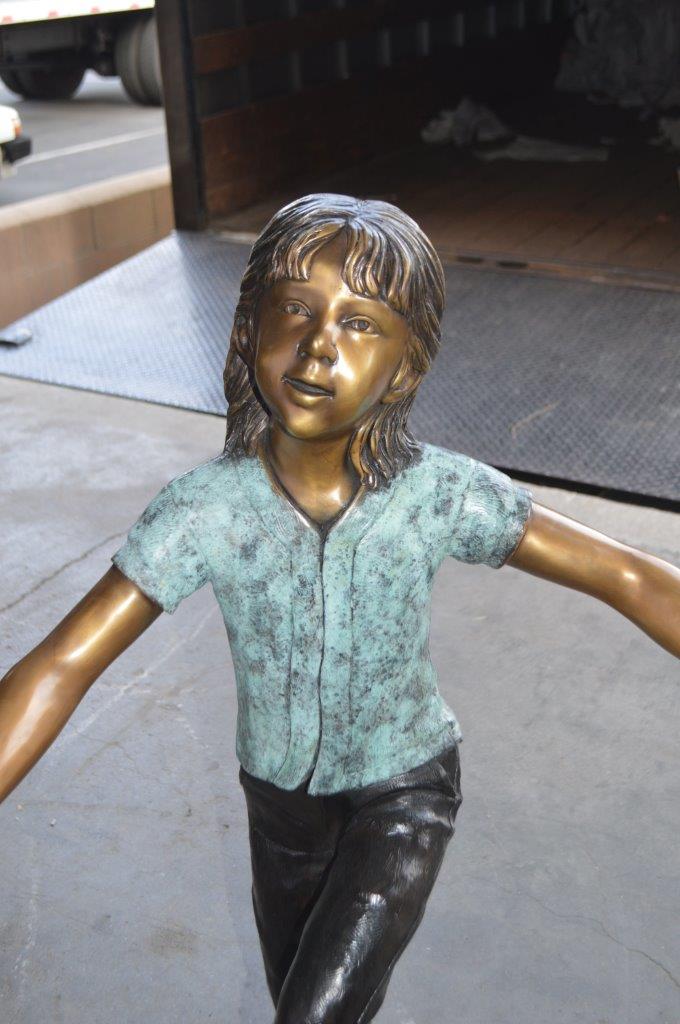 Three children happily holding hands bronze statue - Size: 31"L x 19"W x 41"H.