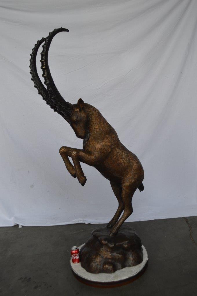 Mountain goat on hind legs bronze statue - Size: 36"L x 16"W x 66"H.