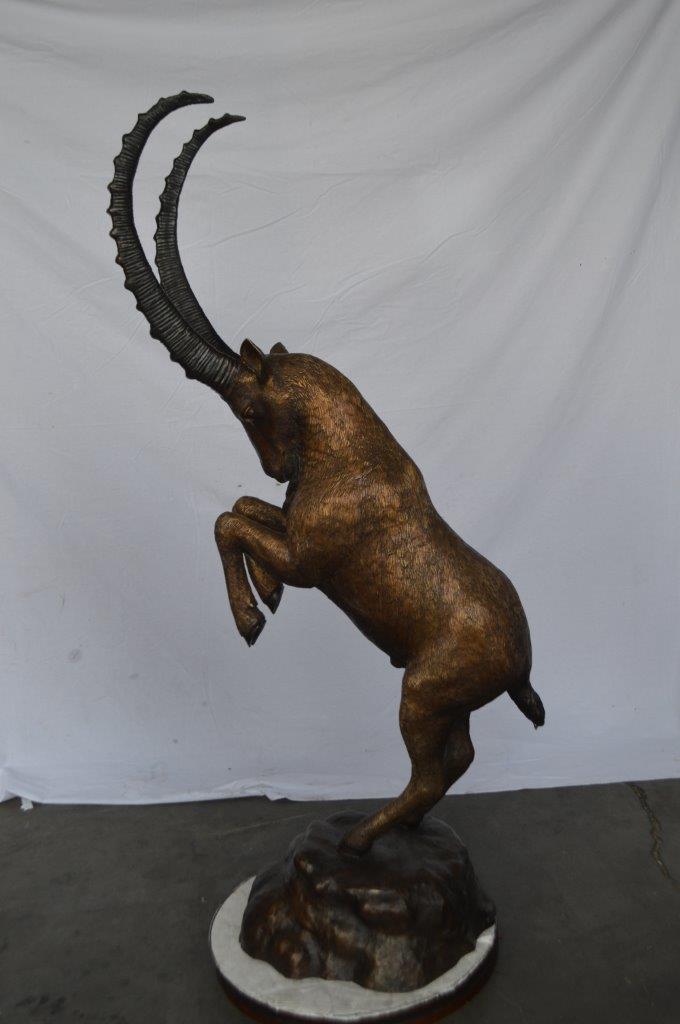 Mountain goat on hind legs bronze statue - Size: 36"L x 16"W x 66"H.