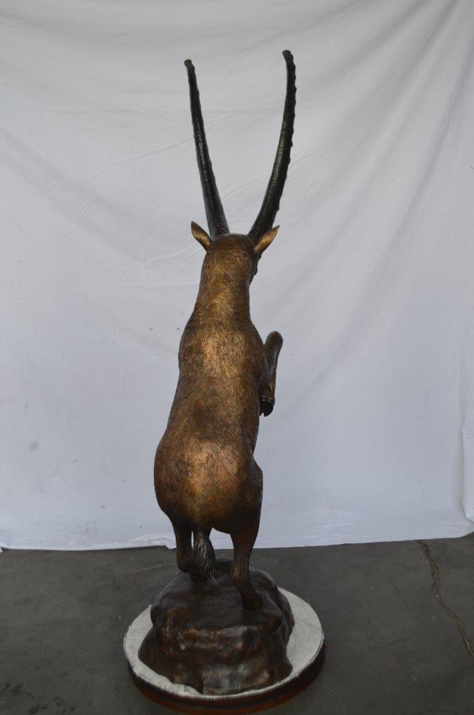 Mountain goat on hind legs bronze statue - Size: 36"L x 16"W x 66"H.