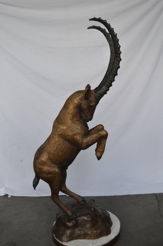 Mountain goat on hind legs bronze statue - Size: 36"L x 16"W x 66"H.
