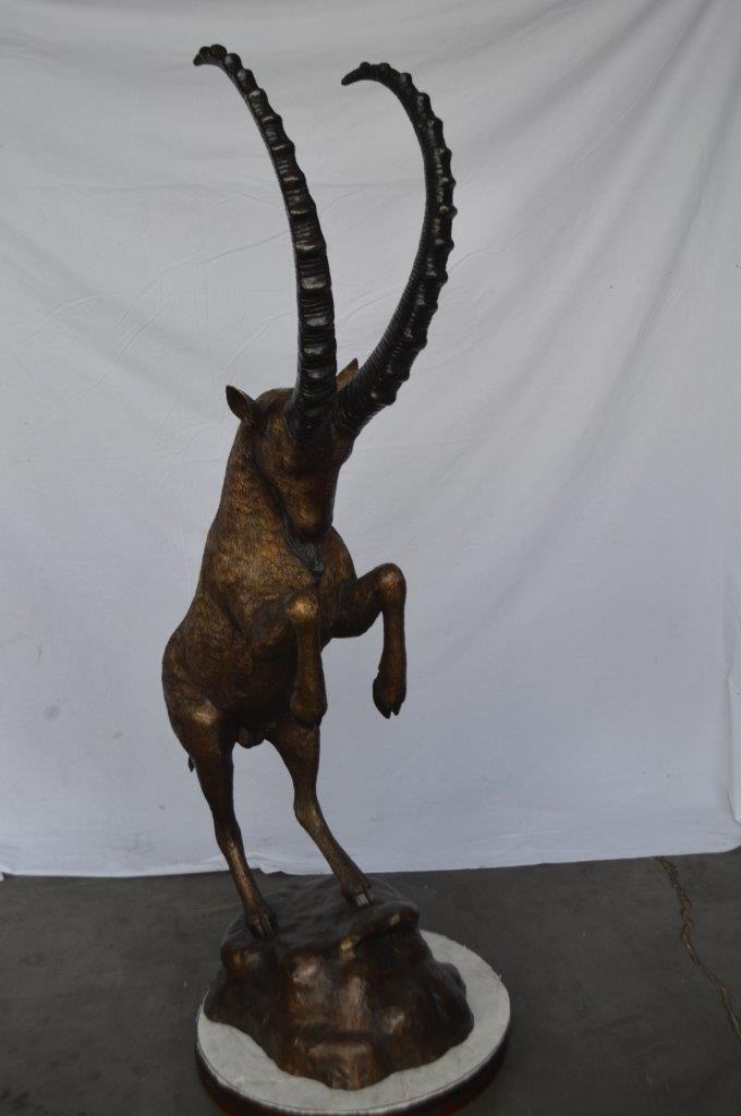 Mountain goat on hind legs bronze statue - Size: 36"L x 16"W x 66"H.