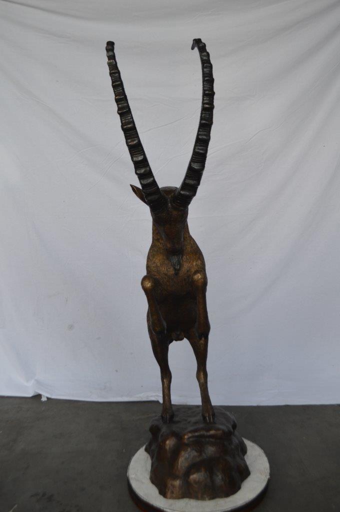 Mountain goat on hind legs bronze statue - Size: 36"L x 16"W x 66"H.