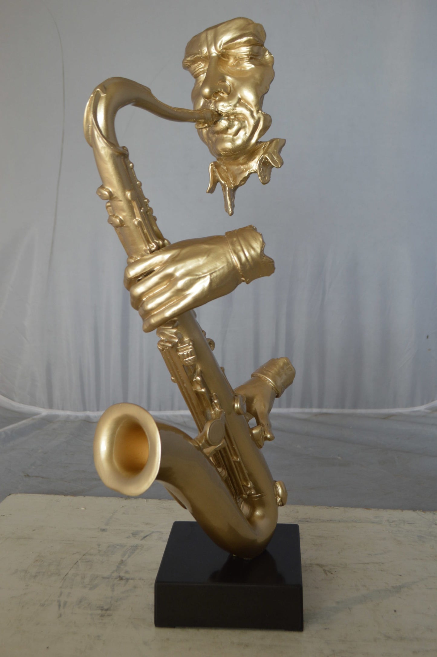 Modern art of a saxophone player resin statue - Size: 13"L x 5"W x 25"H.