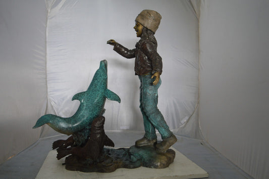 Girl feeding a dolphin and seals bronze fountain - Size: 28"L x 17"W x 37"H.