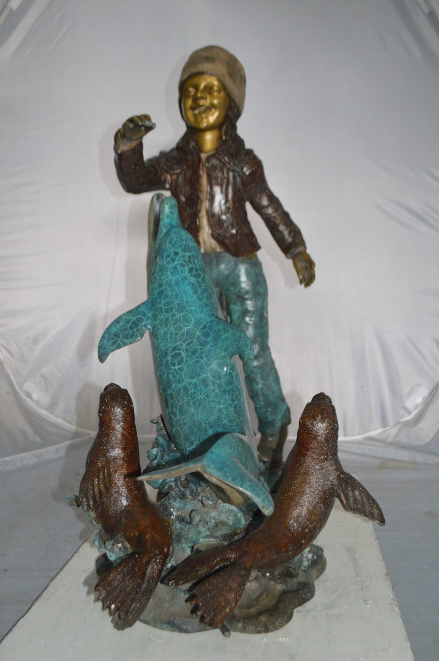 Girl feeding a dolphin and seals bronze fountain - Size: 28"L x 17"W x 37"H.
