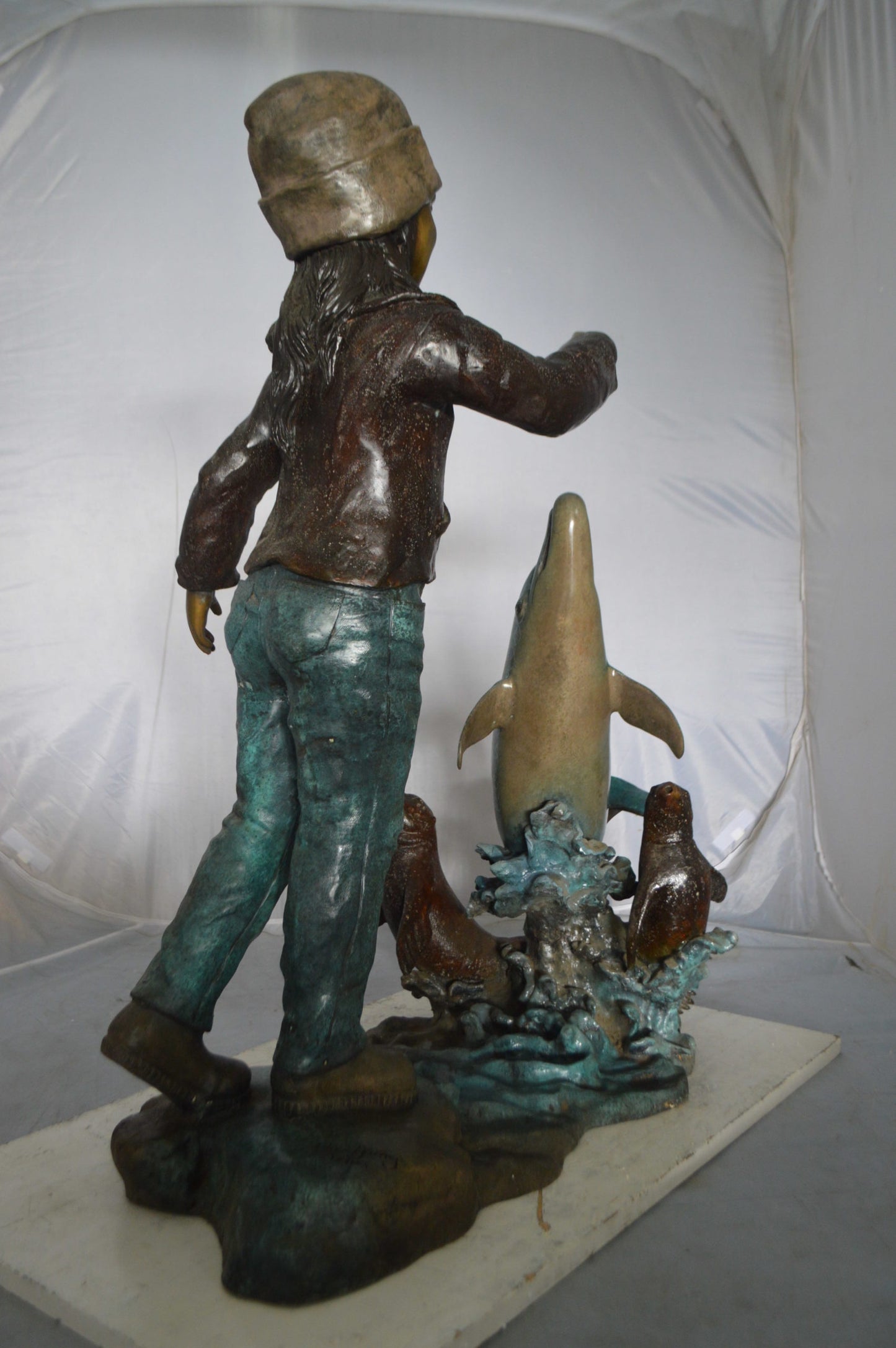 Girl feeding a dolphin and seals bronze fountain - Size: 28"L x 17"W x 37"H.