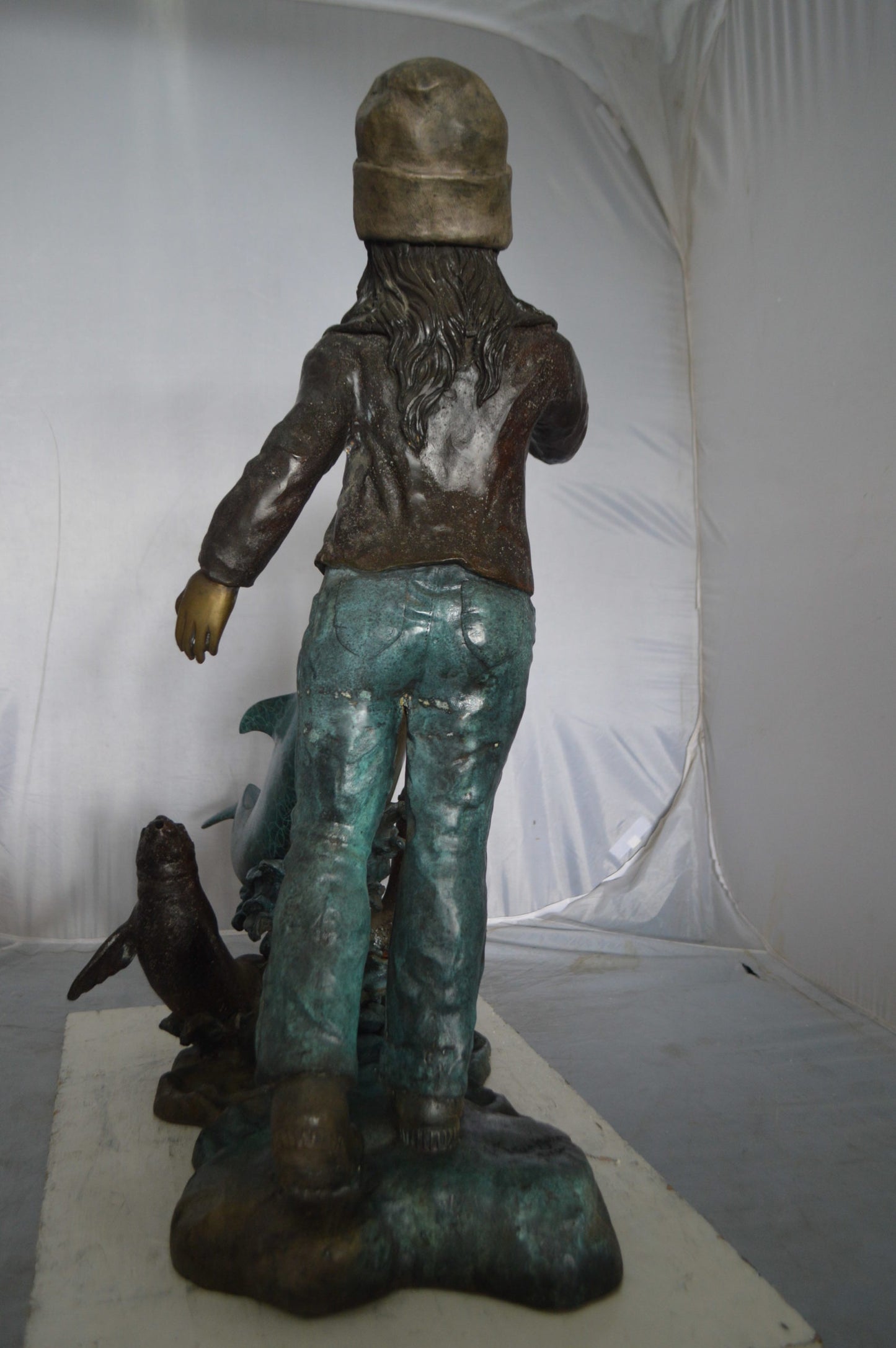 Girl feeding a dolphin and seals bronze fountain - Size: 28"L x 17"W x 37"H.