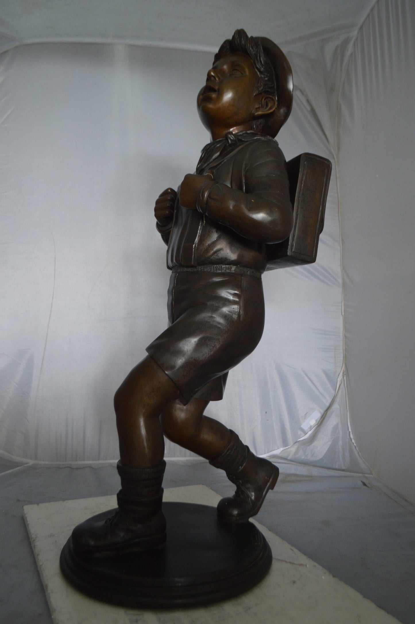 Boy with backpack bronze statue - Size: 20"L x 18"W x 46"H.