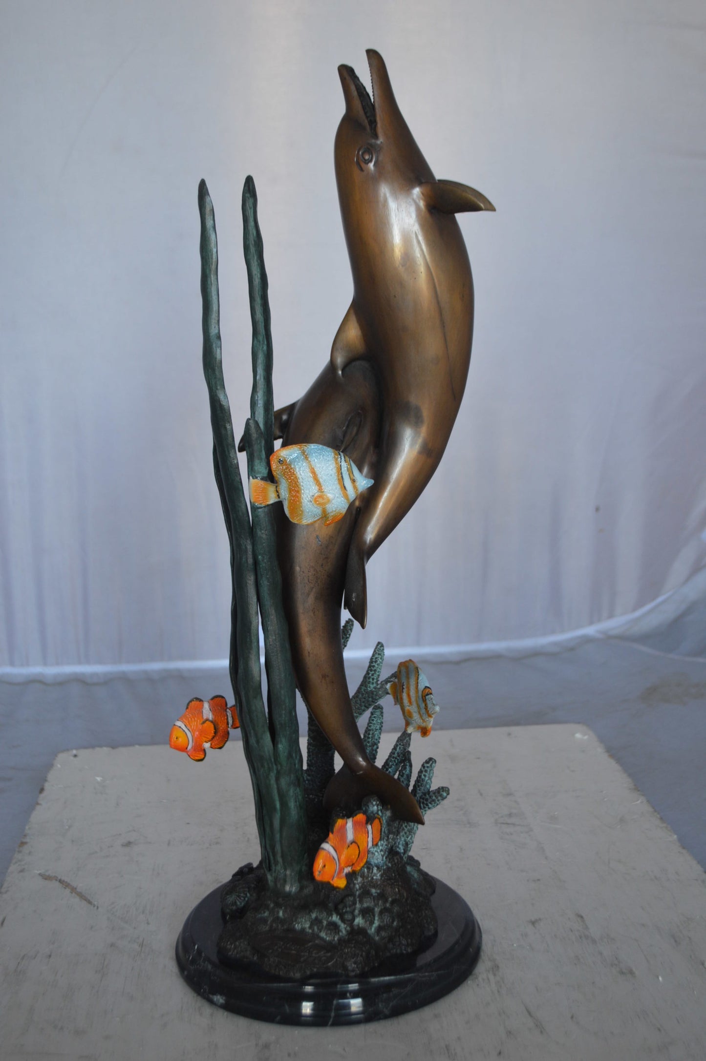 Two dolphins with fish, table top bronze statue. - Size: 8"L x 8"W x 22"H.